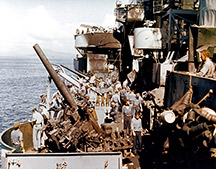 Crewmen of the USS Nashville cleaning up damage caused by the Kamikaze (source Naval History and Heritage Command).